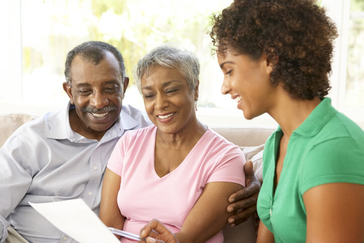 A man and two women on a couch reviewing long-term care insurance at Alpine Skilled Nursing & Rehabilitation in Ruston, LA.