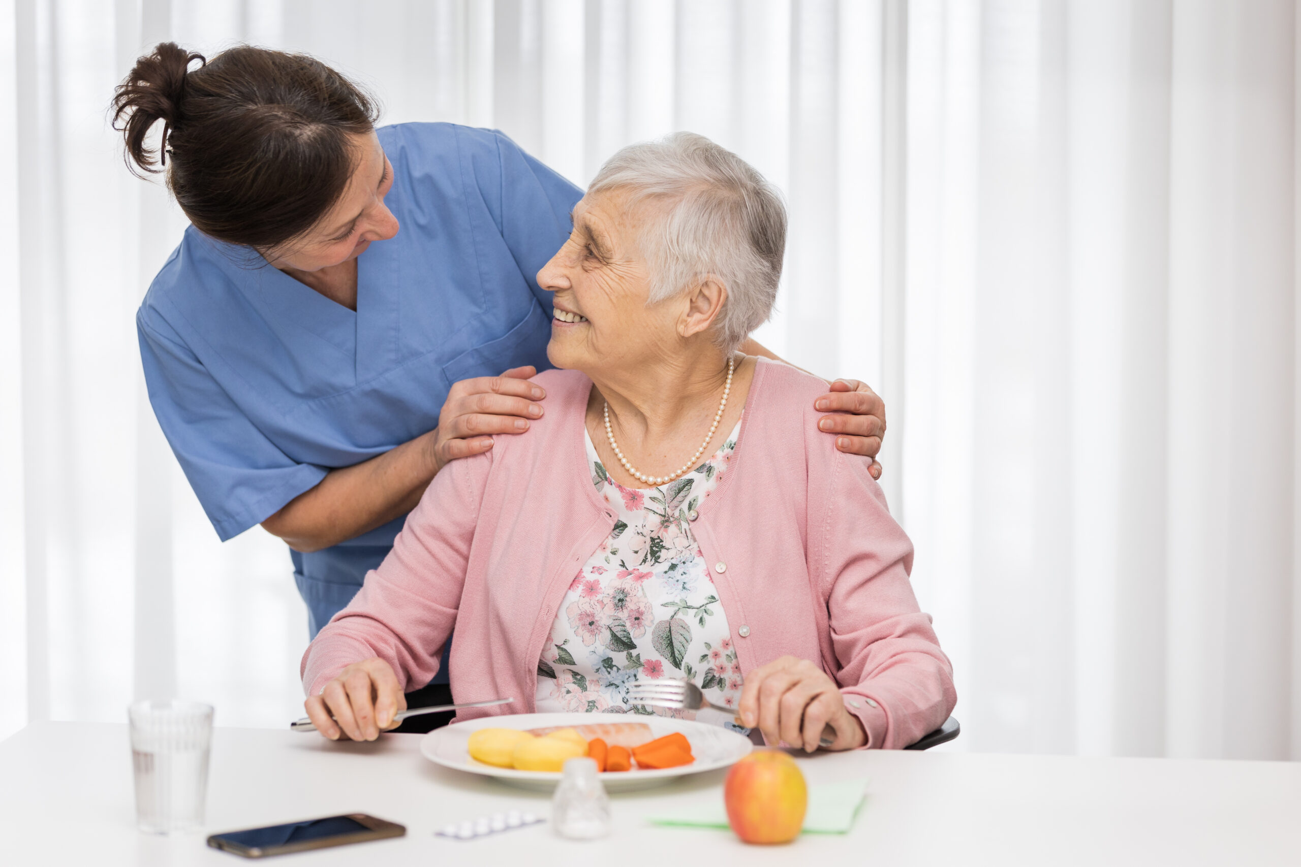 Care Team member supporting senior woman with her Therapeutic diet needs at Alpine Skilled Nursing & Rehabilitation in Ruston, LA.